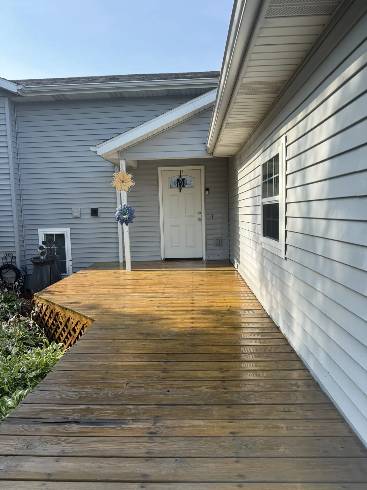 Deck after pressure washing, restored to natural wood tone