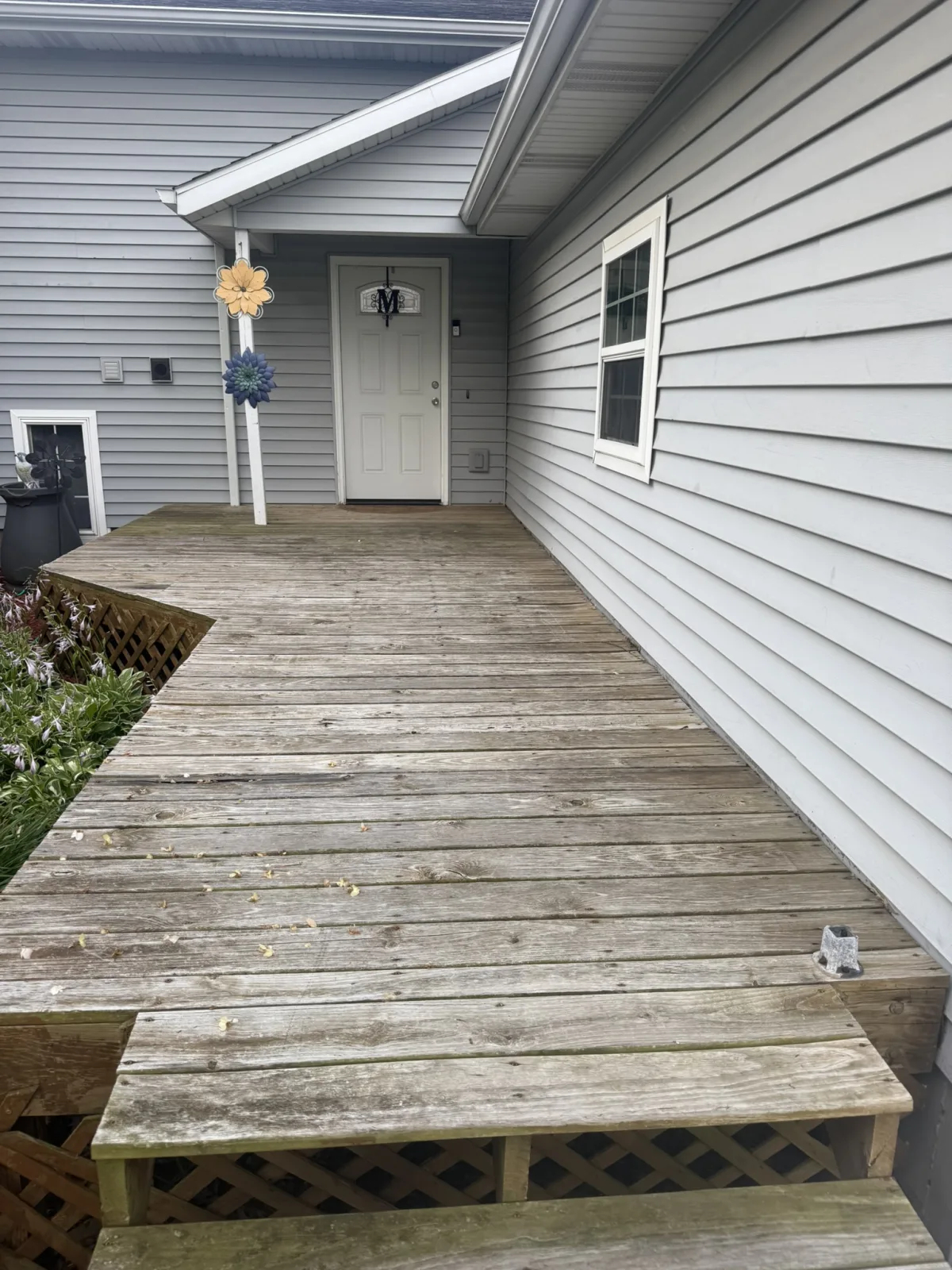 Deck before pressure washing, weathered and gray