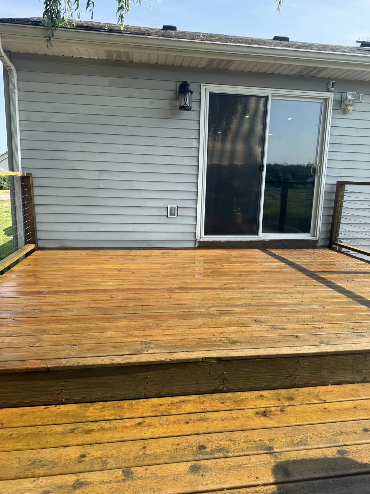 Deck cleaned and restored to a rich natural wood tone